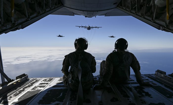 Gassed up U.S. Air Force 2nd Lt. Ella Furlong, left, 418th Test and Evaluation Squadron flight test analyst, and Tech. Sgt. Austin Temple, 418th TES loadmaster, watches two Navy EA-18G Growler aircraft fly in formation with an EC-130H Compass Call aircraft during Gray Flag 24, off the coast of California, Sept. 25, 2024. All three aircraft possess advanced electronic jamming capabilities and are vital for modern combat. (U.S. Air Force photo by Senior Airman Paige Weldon)